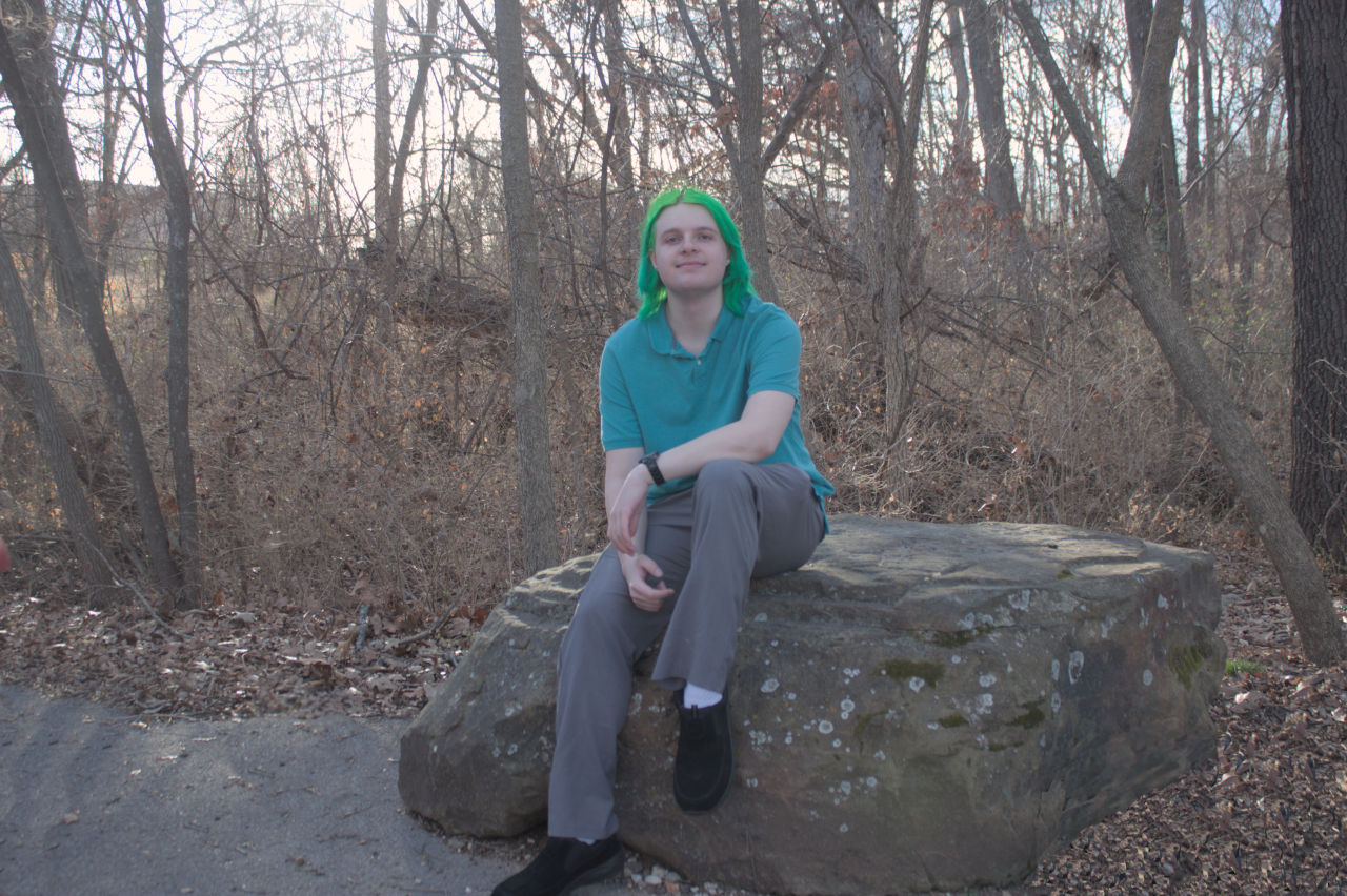 Dallas White sitting on a rock